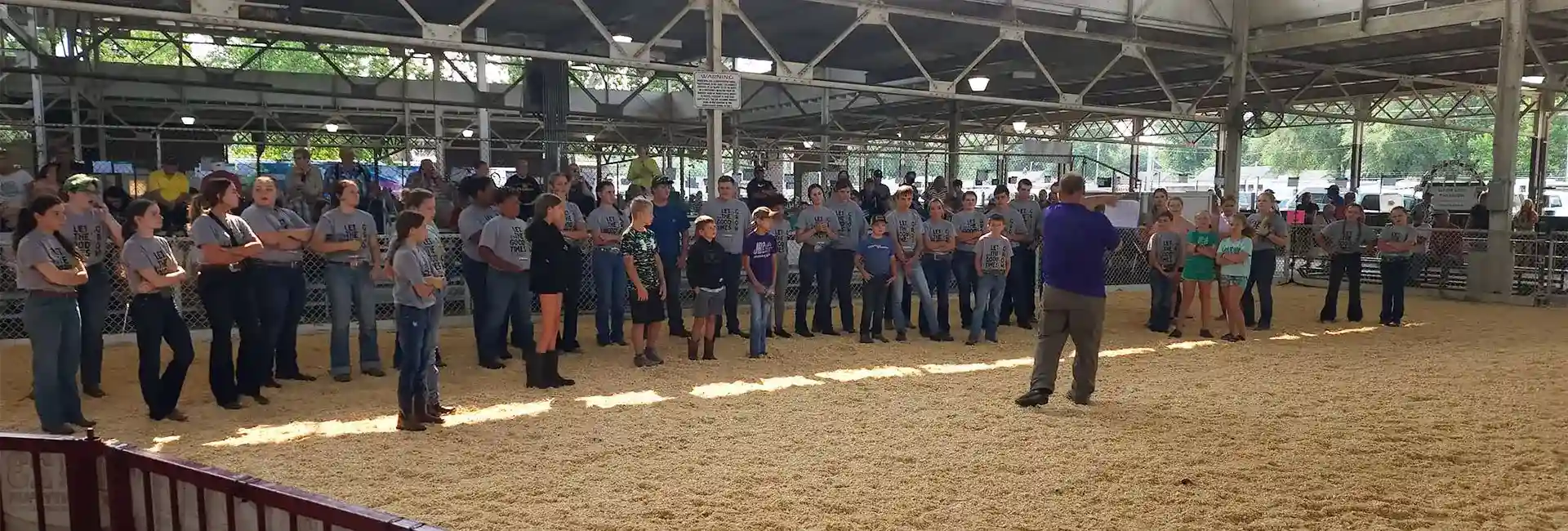 Livestock competition orientation with youth participants and spectators at the Polk County fairgrounds.
